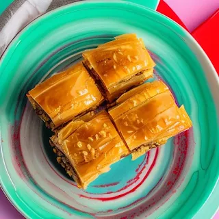 Baklava dessert on a green plate in a colorful kitchen