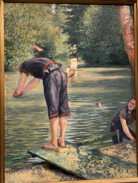 o quadro mostra um jovem  se preparando para mergulhar no rio enquanto outro sai do rio para a margem e um terceiro mais longe dentro do rio observa