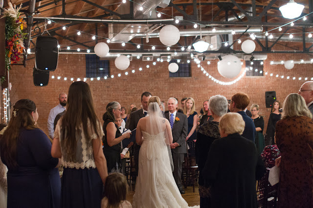 The ceremony taken from a different perspective.  This angle allows for more of the guests to be seen, as well as the festiveness of the atmosphere.  Set at the Hall at the Railhouse located in Norman, OK during the fall of 2016.