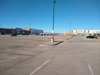 mall parking lot, few cars