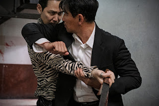 Two men fighting (the man in the suit elbows the man in the striped shirt in the face)