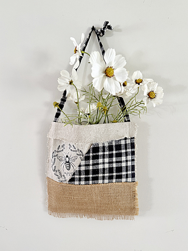 patchwork bag filled with faux flowers
