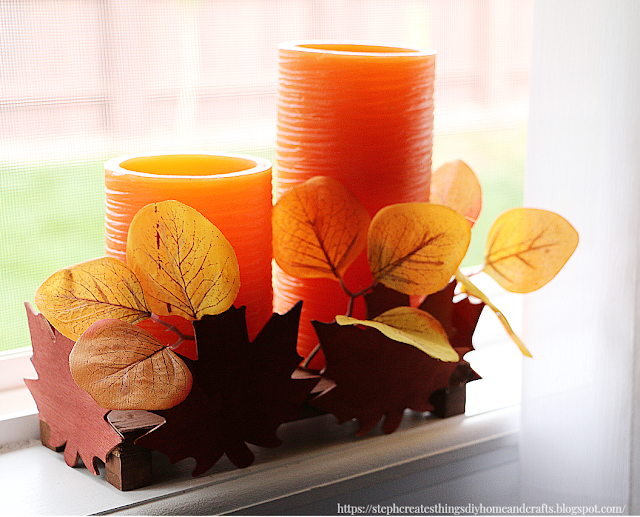 painted leaf wood riser with yellow leaves and candles inside