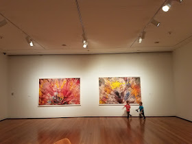 toddlers running through an art museum