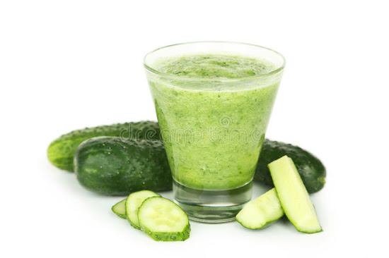 Cucumber juice in a glass and some pieces of cucumber