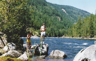 Craig and myself standing on rocks by the Clearwater River during our epic bike journey