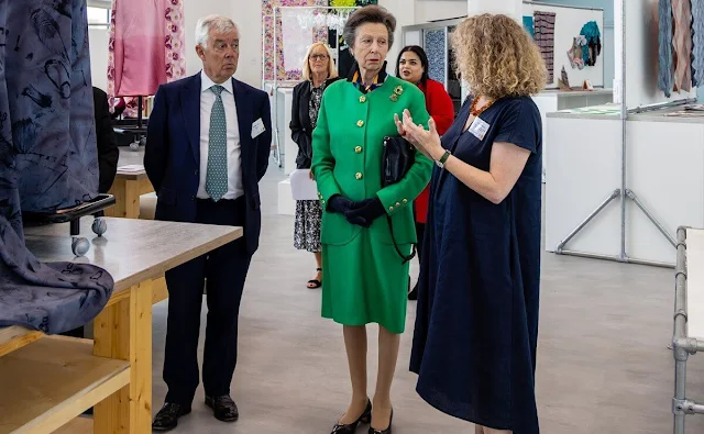 Princess Anne wore a green jacket and midi skirt, and silk shirt. Gold brooch. UK Fashion and Textile Association