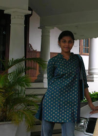 Tamil Nadu girl wearing long tops and jeans and she works at a software company.