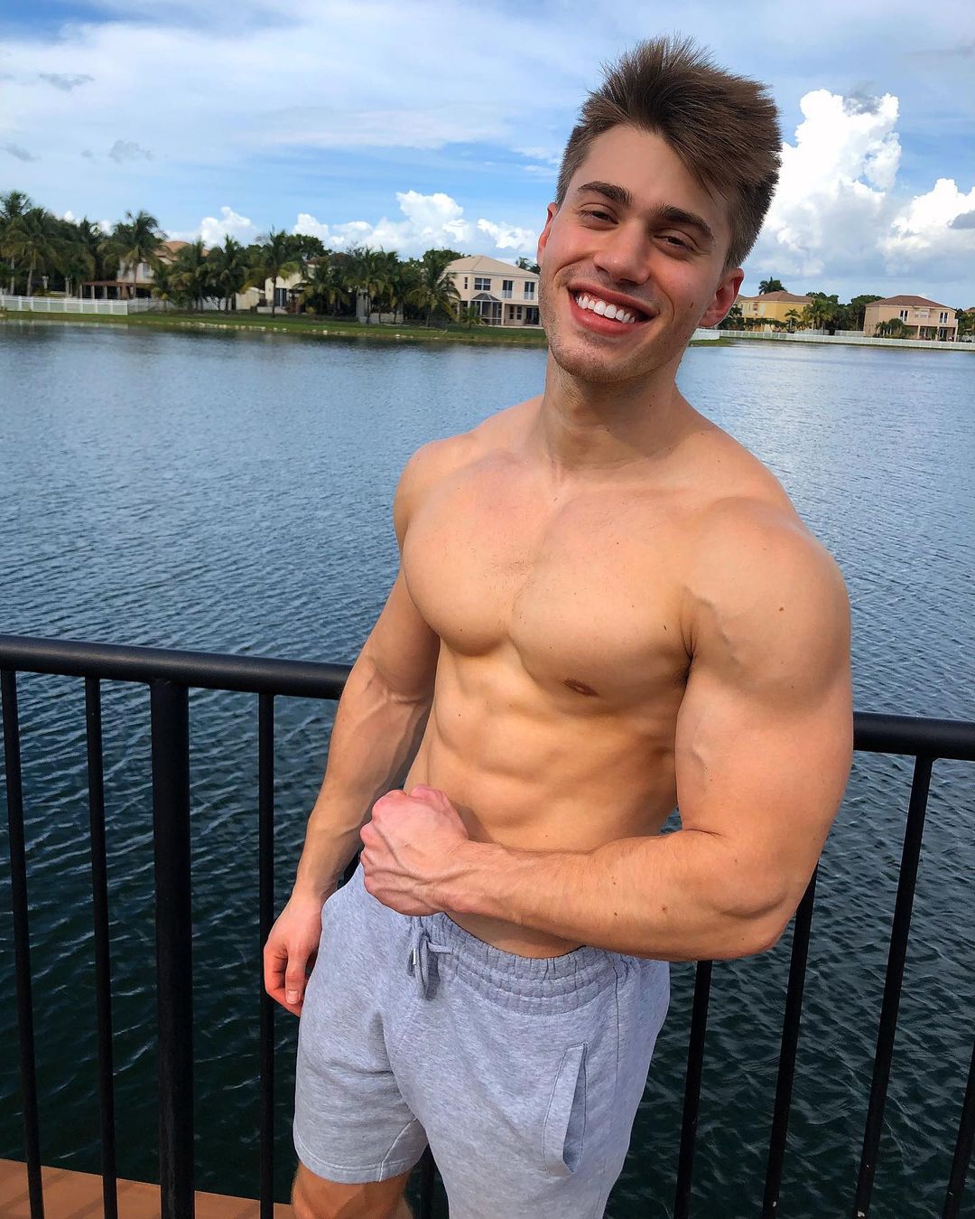 cute-shirtless-muscular-guy-aaron-miller-flexing-biceps-smiling