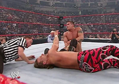 WWE Unforgiven 2003 - Ric Flair looks on as Randy Orton puts a hurtin' on Shawn Michaels