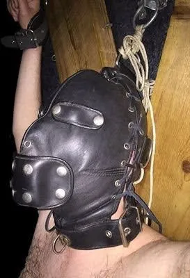 11/12 man bound completely in leather with a hood shirtless tied to wall