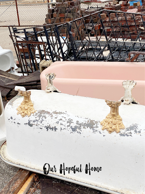clawfoot tub with gold feet and vintage pink tub