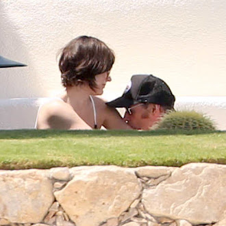 Milla Jovovich seen in bikini poolside while on vacation_26.jpg