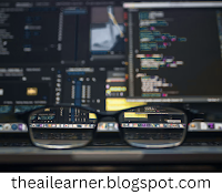 Image of a computer screen displaying code and visual interfaces, viewed through eyeglasses, symbolizing the concept of computer vision and machine perception in artificial intelligence.