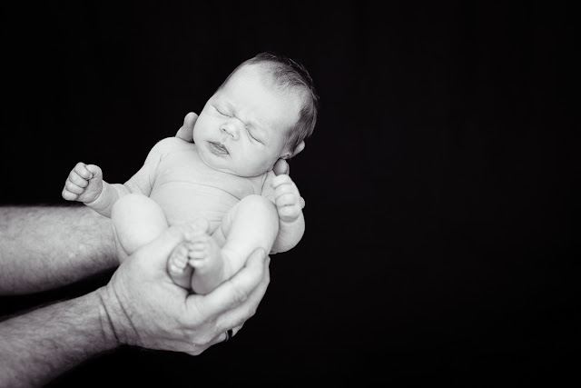 The juxtaposition of Dad's large hands and 3-week old Baby D draws the viewer into this black & white fleeting moment in time.  Taken in their home located in Oklahoma City, OK.