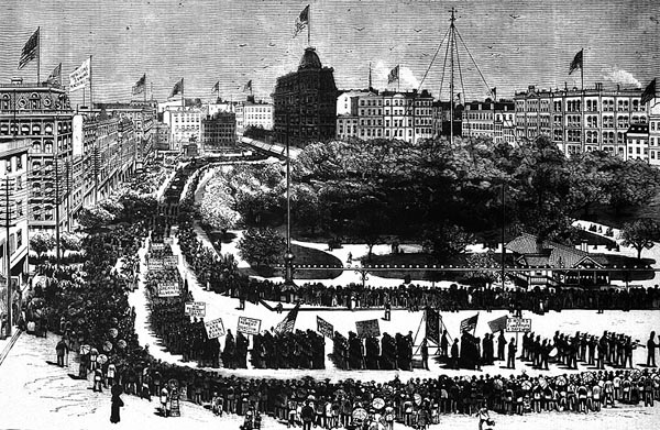 muddy black-and-white graphic of a large number of people marching in an orderly fashion and carrying signs, as others line the street looking on