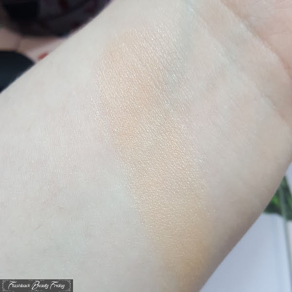 swatch of Lancôme x Olympia Le Tan Cushion Highlighter on pale arm