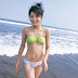 Young Asian girl enjoy on beach in green bikini