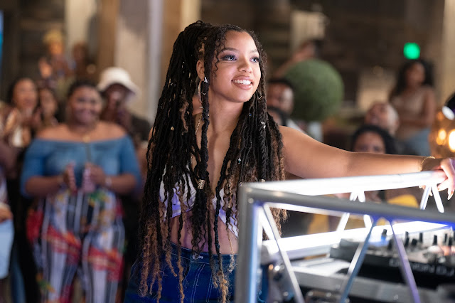 A Black teenager gets ready to perform at the bowling alley