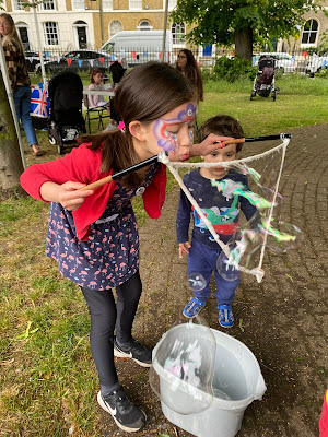 Children playing at making huge bubbles