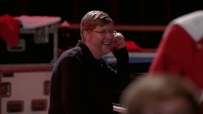Brad the piano man fist pumping the air with a large smile on his face