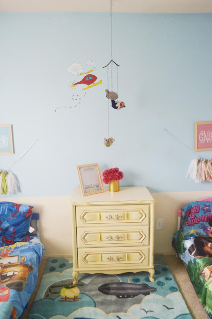 Eclectic DIY and thrifted kids room with tassel garland made with tissue paper