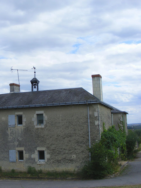 Bell on a winery roof.  Indre et Loire, France. Photographed by Susan Walter. Tour the Loire Valley with a classic car and a private guide.