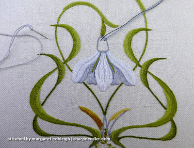 Verious grey crewel wools being tested on the central snowdrop flower to add shadows and depth