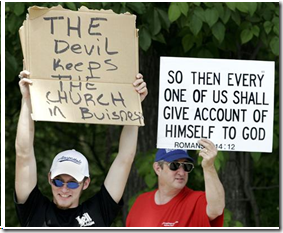 In Hell, Mich., people hold signs on June 6, 2006 (aka 6/6/06). According to the Bible's Book of Revelation, "666" is the mark of the beast. The Book of Revelation also describes hell as a lake of fire.