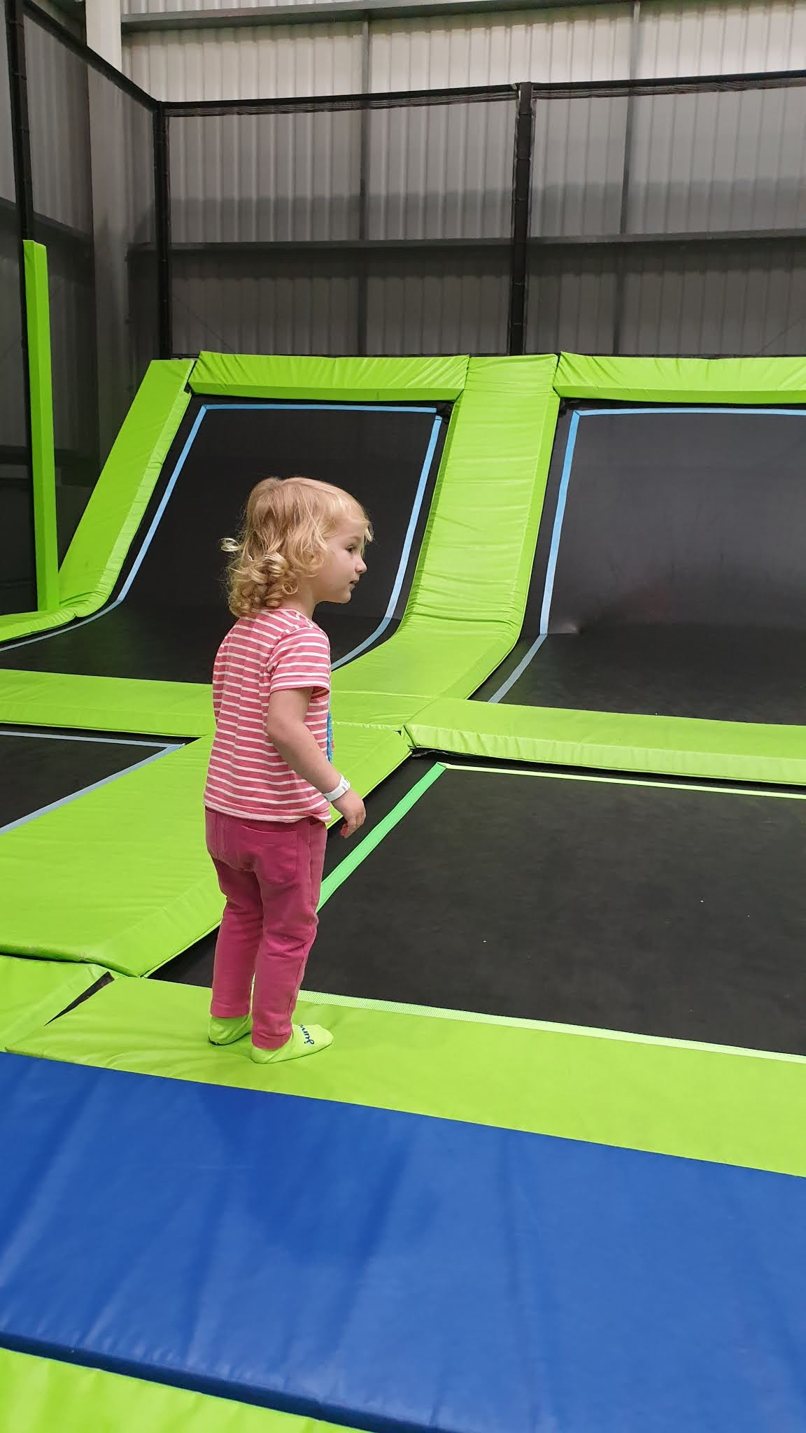 toddler about to jump on a trampoline