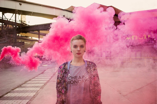 pink smoke behind young woman breast cancer awareness