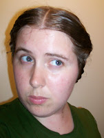 The author giving a quizzical look, her hair twisted back into a basic 1850s style.