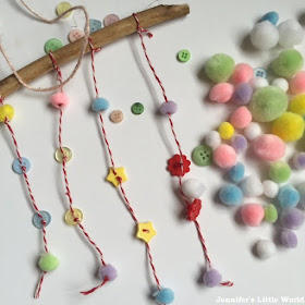 Making a simple stick mobile with buttons and pom poms