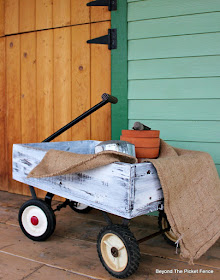 use pallet wood and old wheels to make a wagon for the porch