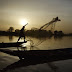 A fisherman casts his nets on the Niger River