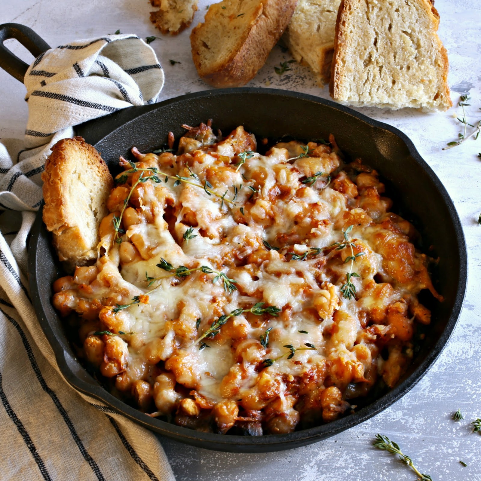 Recipe for white beans cooked in tomato and chicken stock, then baked with Parmesan and mozzarella cheese.