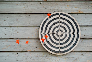 Red-tailed darts around a black and white round target photo by Miikka Luotio on Unsplash - https://unsplash.com/photos/black-and-white-round-logo-i3WlrO7oAHA