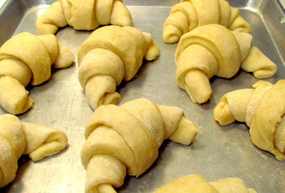 Crescent rolls raising in pan.