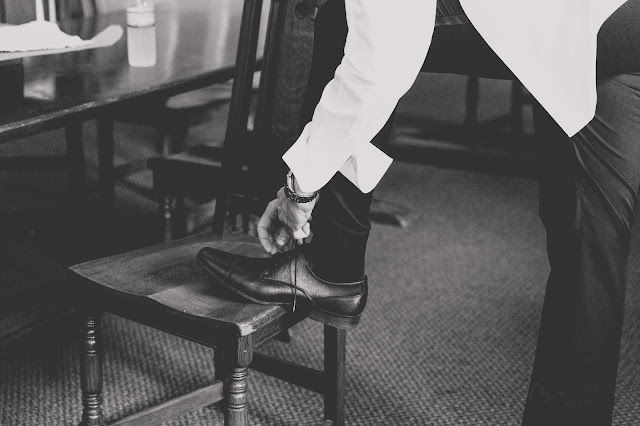 Groom tying shoes
