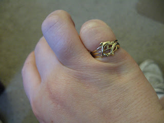 gold ring with 2 dolphins