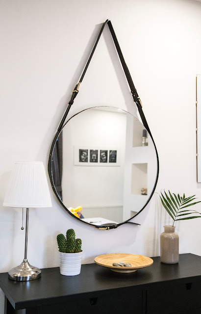 mirror hanging on white wall over console table:Photo by Milada Vigerova on Unsplash