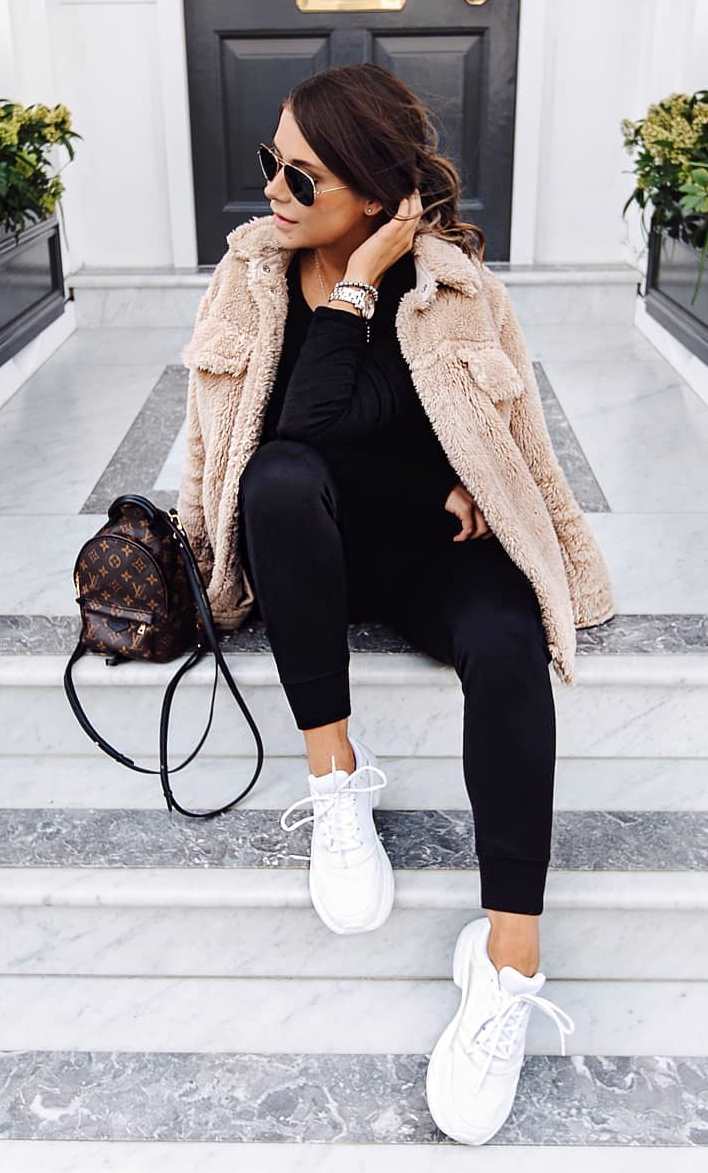 trendy fall outfit idea with sneakers : backpack + beige jacket + black pants + top