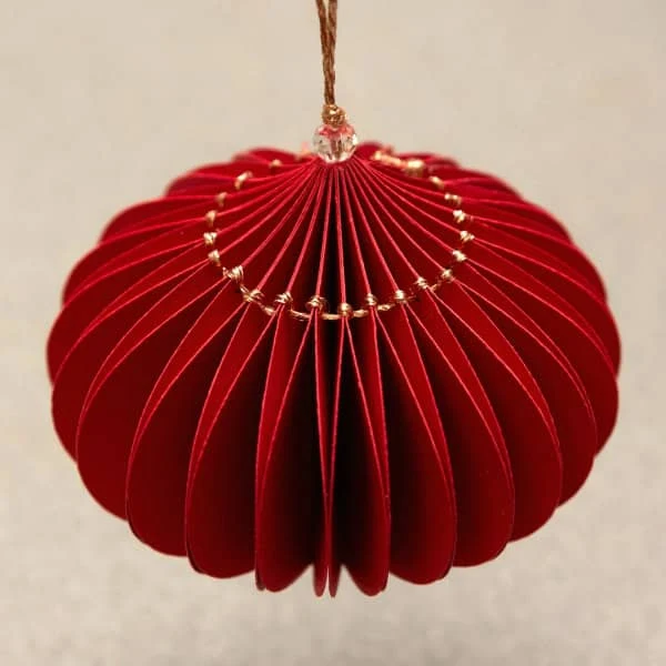 red paper honeycomb ornament with gold metallic hanging thread stitching and hanging loop