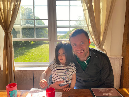 Dad and girl sitting in restaurant in haliburton forest