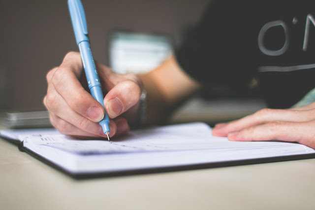 Young man writing in a journal