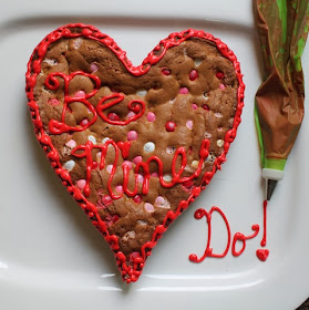 Food Lust People Love: Bake a Big Be Mine Heart Cookie for your sweetheart. A big M&M cookie cake baked in a heart pan and decorated with red sugar icing:  Be Mine!