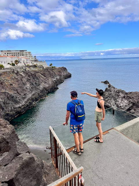 adults on viewing platform above view over sea pool, Santiago del Teide, Tenerife