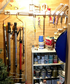 Organize your paint and related painting supplies with shelves and plumbing pipe.