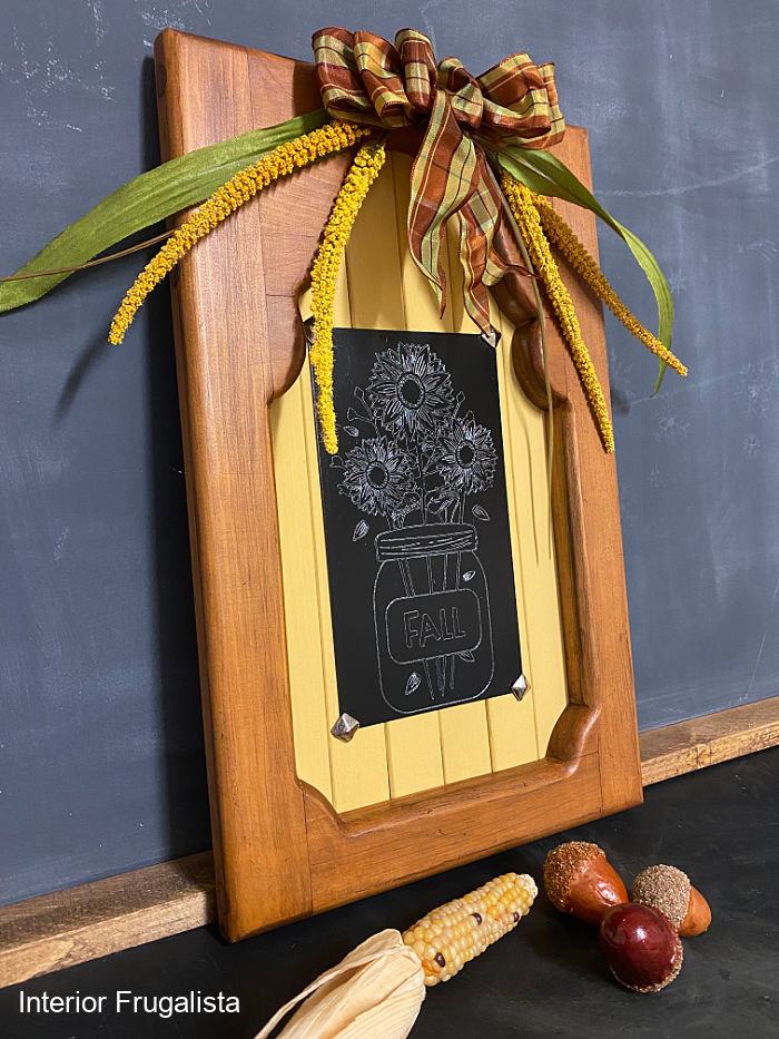 A unique engraved sunflower mason jar fall wall decor idea with Cricut aluminum sheets, repurposed shutter slats and upcycled thrift store wood frame.