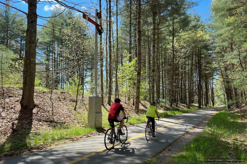 Cyclists wheeling past a restored signal.